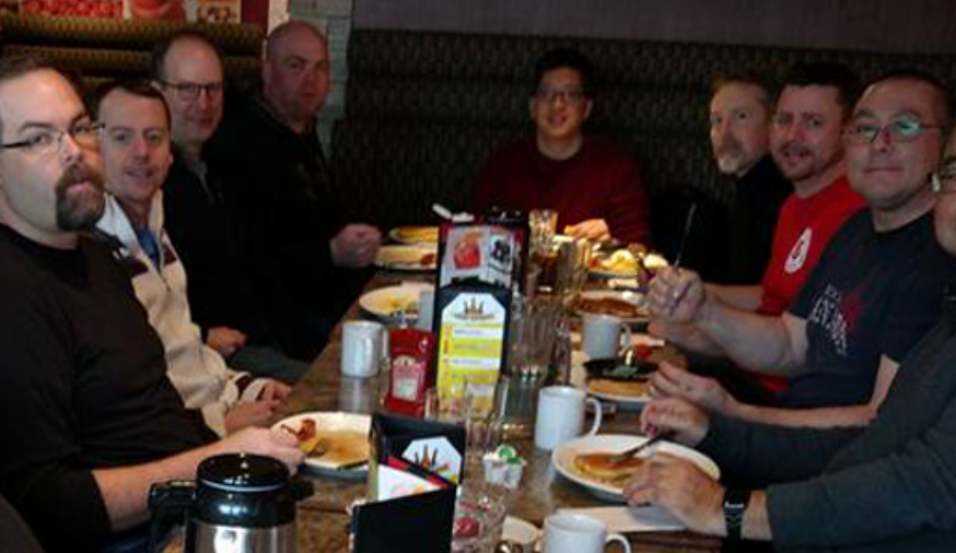 men sharing breakfast